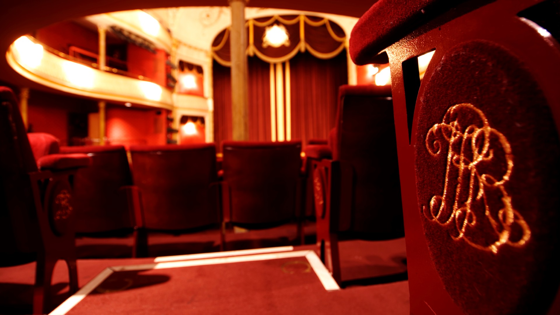 Close up of a red, velvet chair in the Theatre Royal Bath auditorium